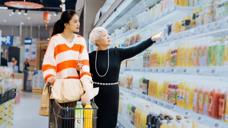 Mother And Daughter Shopping Together In Supermarket